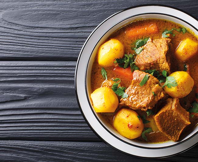 Namibia Potjiekos traditional lamb dish with vegetables close-up in a bowl on the table. 