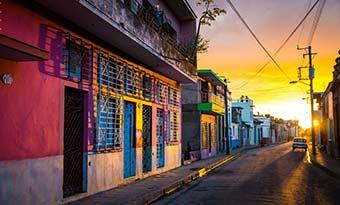 colourful buildings at sunset on backstreets of camaguey cuba