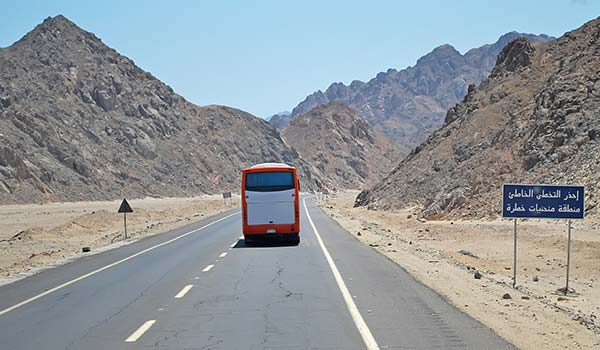 travelling by bus in egypt through desert rock plains