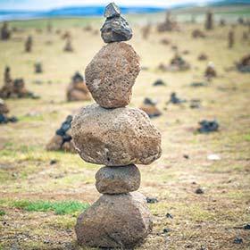 stacks of rocks in a field for reykjavik art festival in iceland