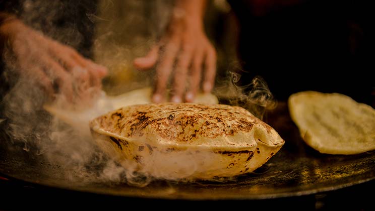 street food vendor making fresh chapatis in india