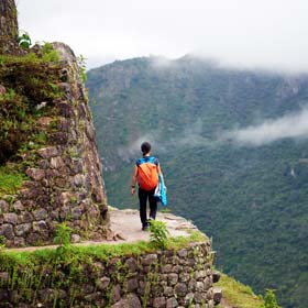 Female solo tourist on  group travel trip on the Inca Trail hike enroute to Machu Picchu, Peru