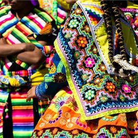 Colourful costume from a peruvian entertainer in a parade celebrating Labour Day