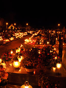 candles and flowers in cemetaries for all saints day in poland