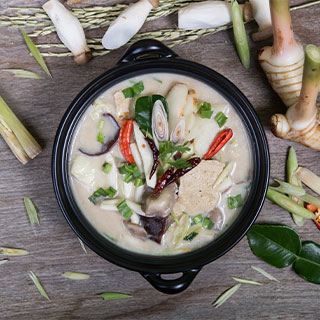 A bowl of traditional chicken in coconut soup which you can find all over Thailand