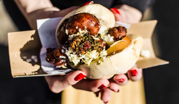 woman holding choripans street food in argentina