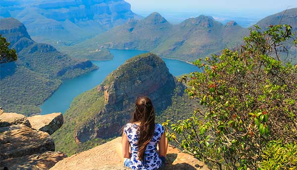 A solo traveller looks out over the cliffs of Blyde River Canyon in South Africa