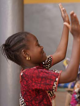 girl in zimbabwe dancing wearing african clothing