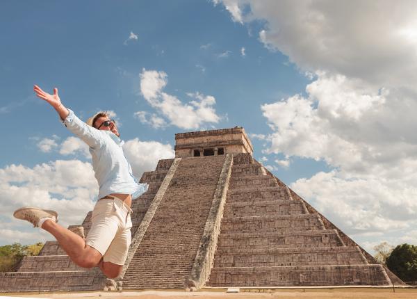 single traveler in awe of his surroundings infront of Chichen Itza, Mexico